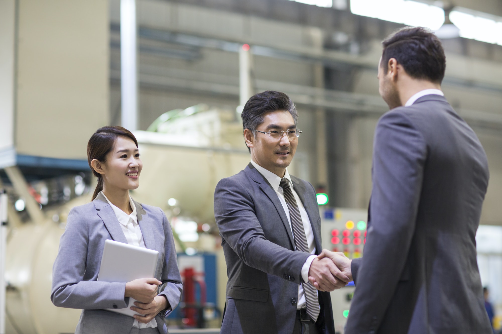 Business people shaking hands in the factory